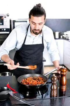 Chef preparing dishes in a frying pan Foto stock