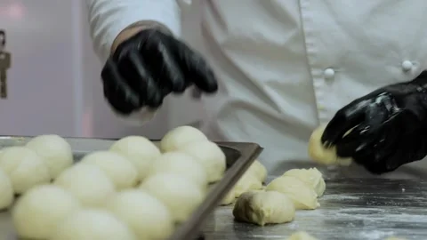The chef is preparing the dough, the cook is working with the dough in the Stock Footage 253315347