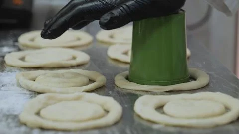 The chef is preparing the dough, the cook is working with the dough in the Stock Photos