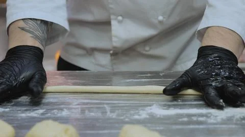 The chef is preparing the dough, the cook is working with the dough in the Stock Photos