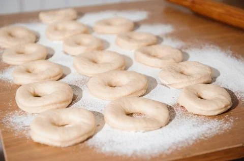Chef preparing dough - cooking donuts process in the kitchen Stock Photos