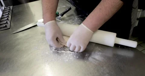 Chef preparing dough with rolling pin for pastry Stock Footage 136406106