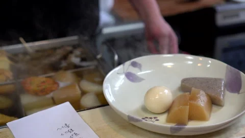 Chef preparing egg and kojac jaoden hot boild daikon radish in Japanese sty.. Stock Footage 259302137