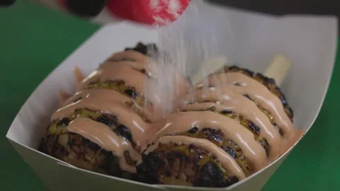 Chef preparing elote corn sprinkling cheese on grilled corn, close-up Stock Footage 246237521