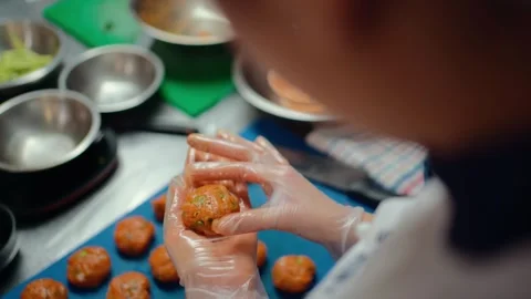 Chef is preparing fishcake with gloves in professional kitchen. Stock Footage 307979844