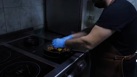 Chef preparing Flambe style dish on a pan.mixed colorful vegetables tossing them Stock Footage 126812289