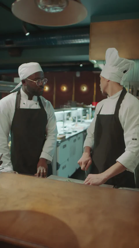 Chef Preparing Food and Speaking in Apprentice in Kitchen of Restaurant 스톡 동영상 273451084