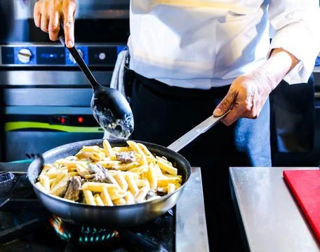 Chef preparing food in the kitchen, chef cooking, closeup Stock Photos
