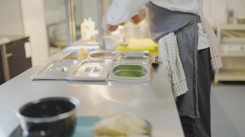 A chef is preparing food in a kitchen Stock Footage 306577019
