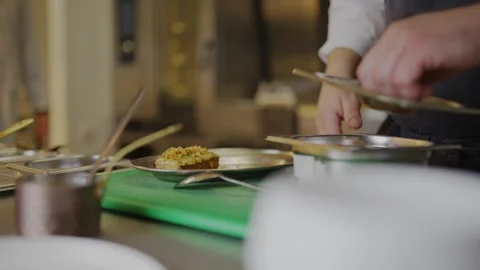 A chef is preparing food in a kitchen Video stock 306577147