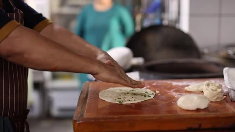 Chef Preparing Fresh Garlic Naan Flatbread in Traditional Kitchen Stock Footage 345714561