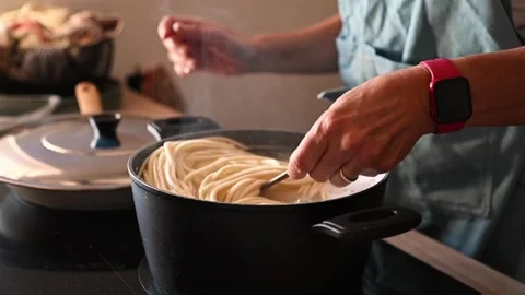 Chef preparing fresh handmade pasta in professional kitchen with steamy pot Video stock 346976650