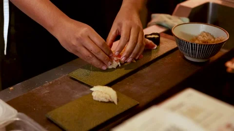 Chef Preparing Fresh Nigiri Sushi with Blowtorch and Precise Plating Stock Footage 327121265