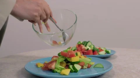 Chef preparing fresh vegetable salad with lettuce, tomatoes, cucumbers and bell Stock Footage 306714522
