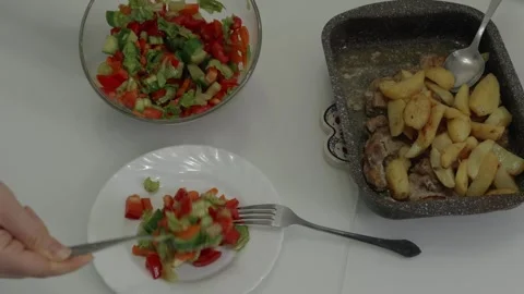 Chef preparing fresh vegetable salad with roasted meat and potatoes Stock Footage 321041654