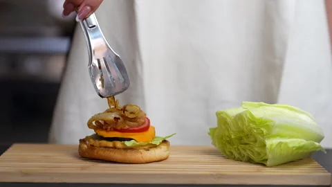 Chef Preparing Gourmet Burger with Caramelized Onions Stock Footage 315299687