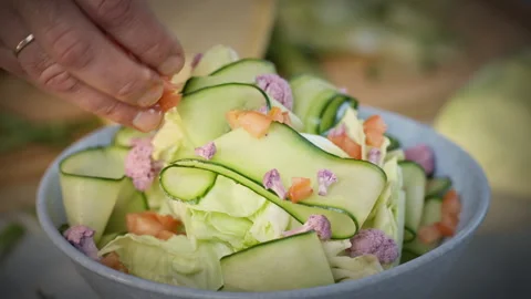 Chef preparing green salad from cucumber, cabbage, tomatoes and cauliflower. Stock Footage 302585854