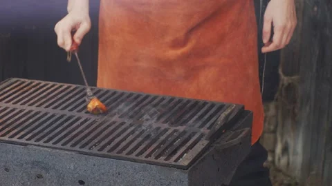 Chef preparing grill for barbecue with pork fat Stock Footage 146791844