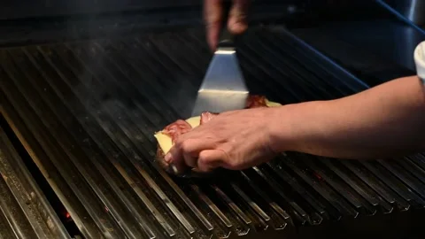 Chef preparing hamburger on the kitchen griddle Stock-Footage 132530505