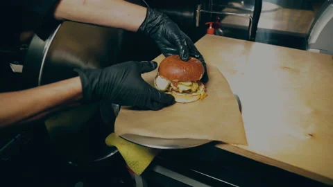 Chef preparing hamburger in restaurant kitchen Stock Footage 208380930