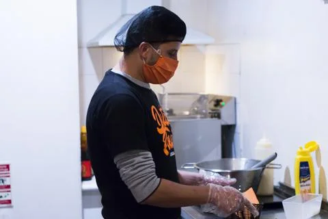 A chef preparing ingredients for some fried american food. Man fried unhealth Stock Photos