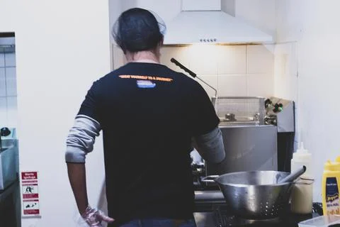 A chef preparing ingredients for some fried american food. Man fried unhealth Stock Photos