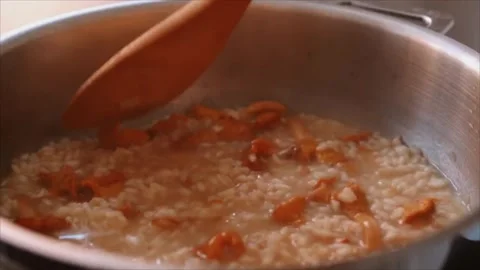 Chef preparing Italian mushroom risotto (risotto ai funghi) Stock Footage 251995669