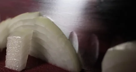 Chef preparing meal, chopping onion with a knife on a cutting board. Close up Stock Footage 290128516