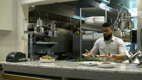 Chef preparing meal on a counter 動画素材 75247795