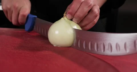 Chef preparing meal out of vegetables and meat, chopping onion with a big knife Stock Footage 290127850