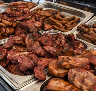 Chef preparing meat on the grill, during outdoor outside food festival, food  Stock Photos