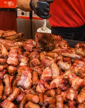 Chef preparing meat on the grill, during outdoor outside food festival, food  Foto stock