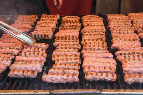 Chef preparing meat on the grill, during outdoor outside food festival, food  Stock Photos