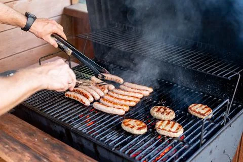 Chef preparing meat on the grill, during outdoor outside food festival, food Stock Photos