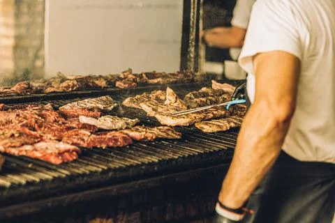 Chef Preparing Meat on the Grill Stock Photos