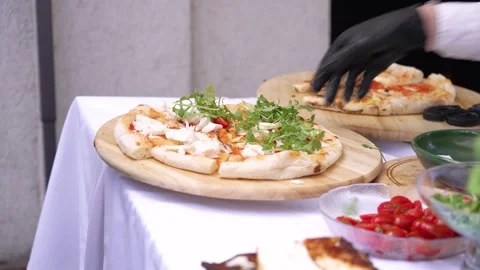Chef preparing Neapolitan pizza with fresh ingredients at a food festival event Stock Footage 346186602