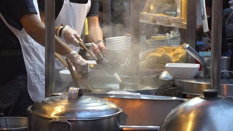 Chef preparing noodle for customer in Bangkok's Chinatown, Thailand Stock Footage