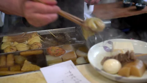Chef preparing oden hot boild daikon radish in Japanese style soup hot meal Video stock 259302176