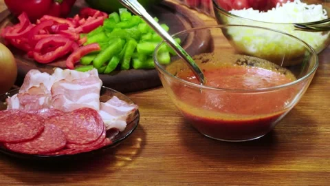 Chef preparing  with pizza with bacon, pepperoni and bell pepper Stock Footage 98717641