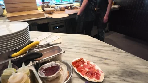 Chef Preparing Prosciutto Appetizer on Marble Counter in Professional Kitchen Stock Footage 339119319