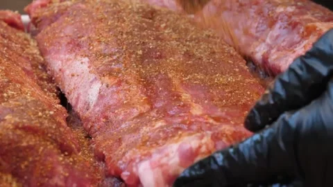 Chef Preparing Raw BBQ Pork Ribs with Dry Rub Seasoning Stock Footage 338212216