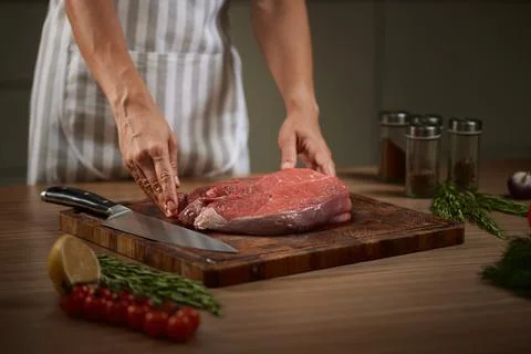 Chef preparing raw beef meat on cutting board Stock Photos