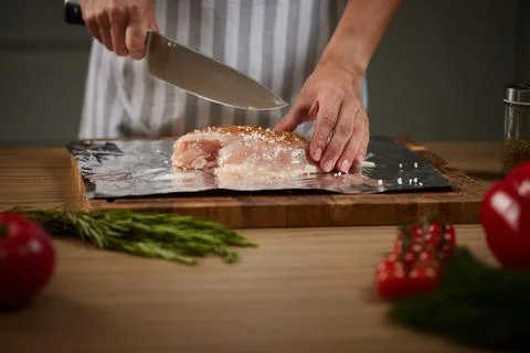 Chef preparing raw chicken meat with seasoning Stock Photos
