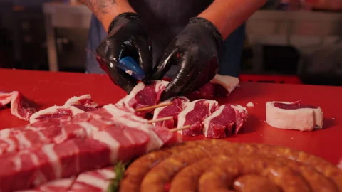 Chef preparing the raw lamb loin chops for barbecue making a queue. Stock Footage 295273516