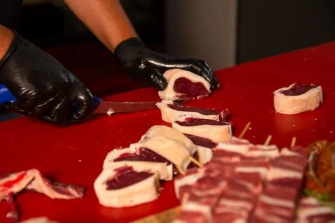 Chef preparing the raw lamb loin chops for barbecue making a queue. Stock Photos