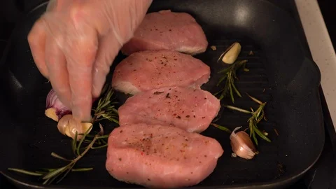 Chef preparing raw pork for cooking with seasoning Video stock 105126247