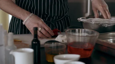 Chef preparing a roasted red pepper in interior kitchen with soft day lighitng. Stock Footage 199459143