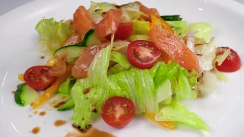 Chef preparing a salad with salmon, adding grated cheese Stock Footage 84261178