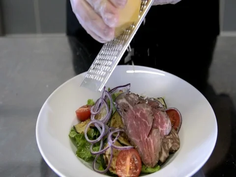 Chef preparing a salad. Spread tomatoes, onion falls.Slow motion Stock Footage 76054824