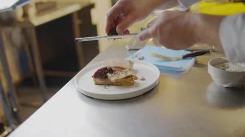 A chef is preparing a sandwich on a plate Stock-Footage 306576794